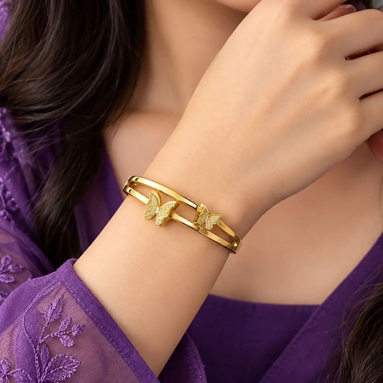 gold-toned double-band butterfly bangle.